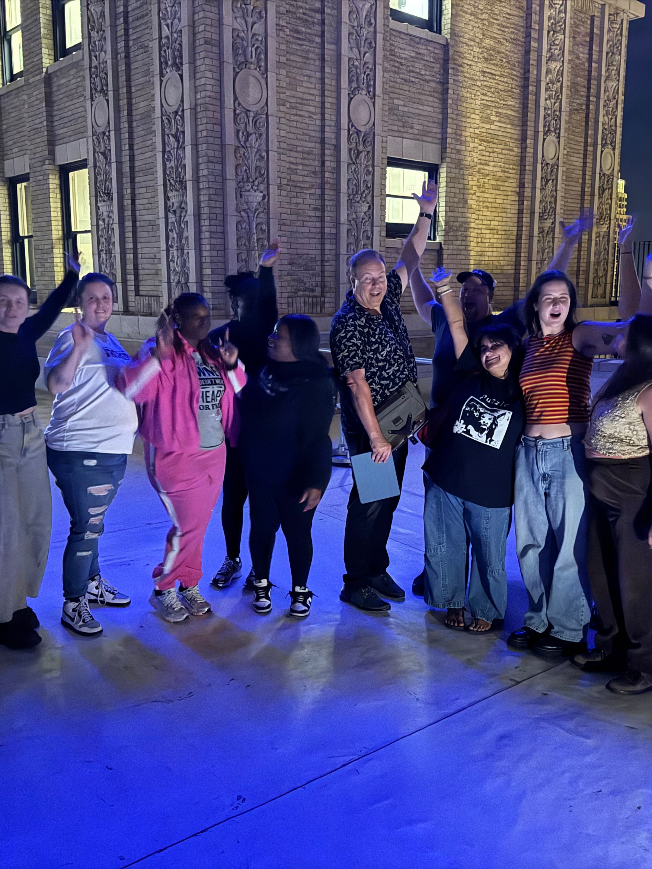 a group of people standing on a sidewalk